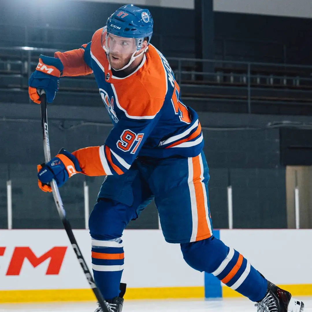 Blue and orange edmonton oilers hockey jersey with white trim, featuring the number 91 on the back.