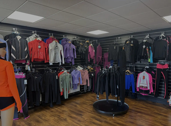 A black circular display stand with a flat top and slightly raised edges, positioned centrally in the store.