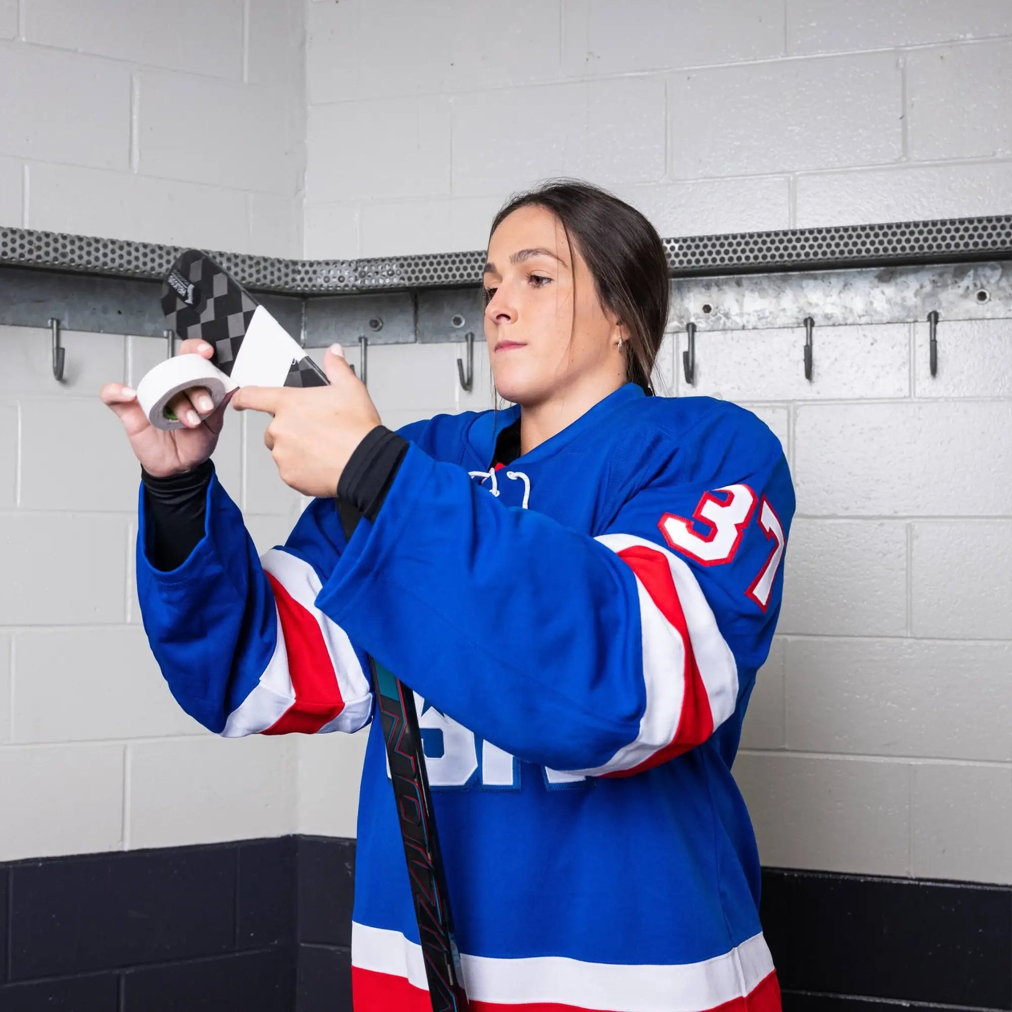 Blue, red, and white hockey jersey with number 37 on the sleeve